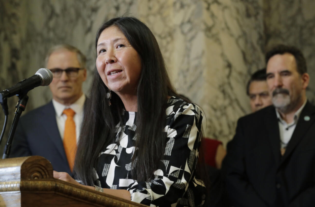 Washington state Rep. Debra Lekanoff, D-Bow, speaks during a bill signing ceremony for a measure that expands voting services on tribal reservations, Thursday, March 14, 2019, at the Capitol in Olympia, Wash. The bill requires county officials to establish at least one voting drop box on any Indian tribal reservation if requested by the tribe, and allows tribal members to register to vote using non-traditional addresses. (AP Photo/Ted S.