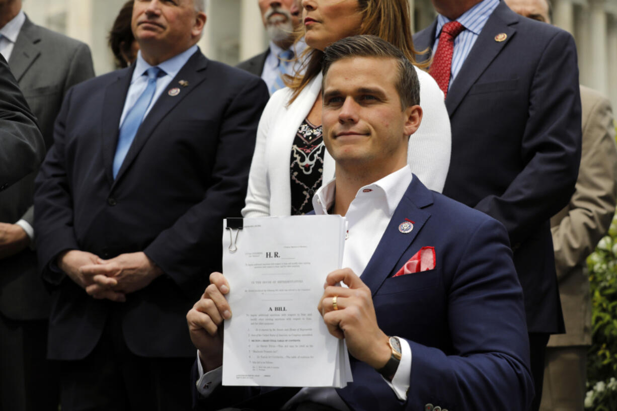 Congressman Madison Cawthorn, R-N.C., holds a copy of the bill while former U.S. Secretary of State Mike Pompeo introduces the Maximum Pressure Act against Iran on Capitol Hill in Washington, D.C., on Wednesday, April 21, 2021.