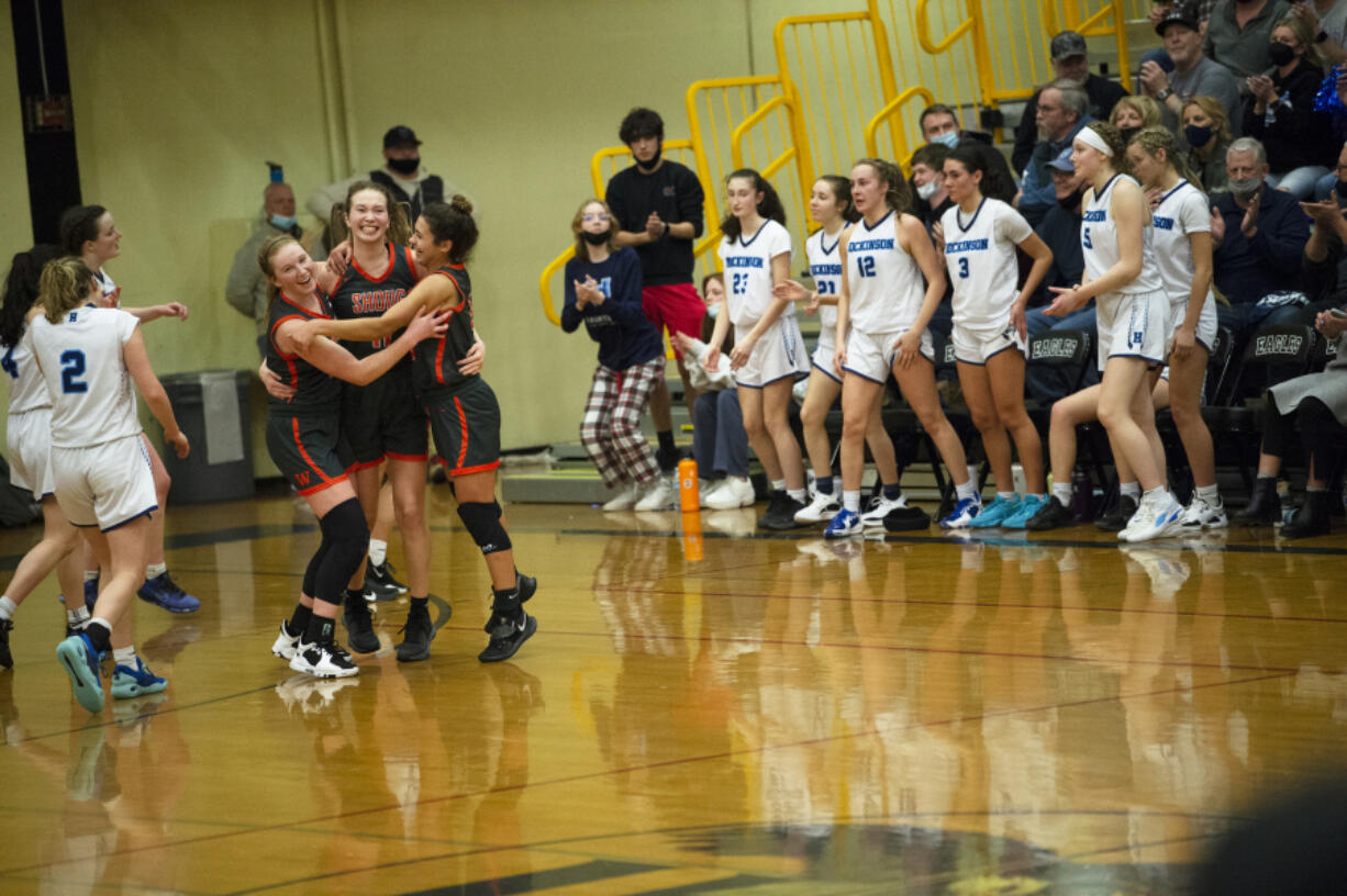 Washougal?s (left to right) Savea Mansfield, Samantha Mederos and Chloe Johnson celebrate after the final horn sounds at  Washougal?s 56-43 win over the Hawks in a 2A girls basketball district winner-to-state game.