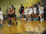 Washougal?s (left to right) Savea Mansfield, Samantha Mederos and Chloe Johnson celebrate after the final horn sounds at  Washougal?s 56-43 win over the Hawks in a 2A girls basketball district winner-to-state game.