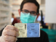 SureCare Pharmacy manager Oscar Uribe shows off a package of Pfizer Paxlovid pills inside of Esperanza Health Center in Chicago's Brighton Park neighborhood on Thursday, Jan. 13, 2022. Pfizer's Paxlovid  is a treatment for COVID-19.