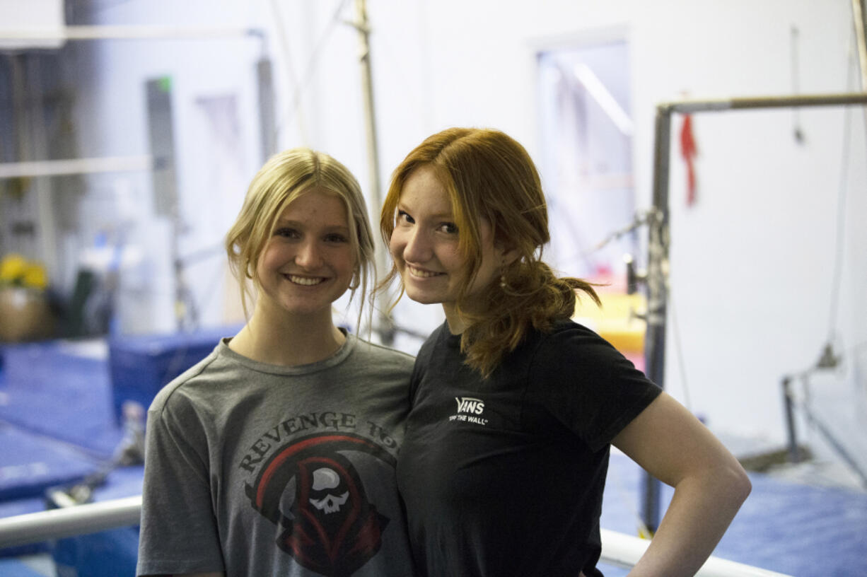 Sisters Peyton Cody (left) and Kennedy Cody pose at Vancouver Elite Gymnastics Academy during a practice with the Camas High School team.