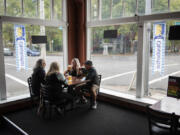 Craig Miller, from left, his wife Laurie, both of Salem, Ore., and Jennifer Miller and her husband Scott, both of West Linn, Ore., enjoy beers together at Trusty Brewing Co. in Vancouver in September 2020. Trusty Brewing is for sale because the owner needs to care for a family member experiencing medical issues.