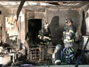 Deputy fire marshals investigate a Vancouver house fire. The Vancouver Fire Marshal's Office investigated 276 fires in 2021.