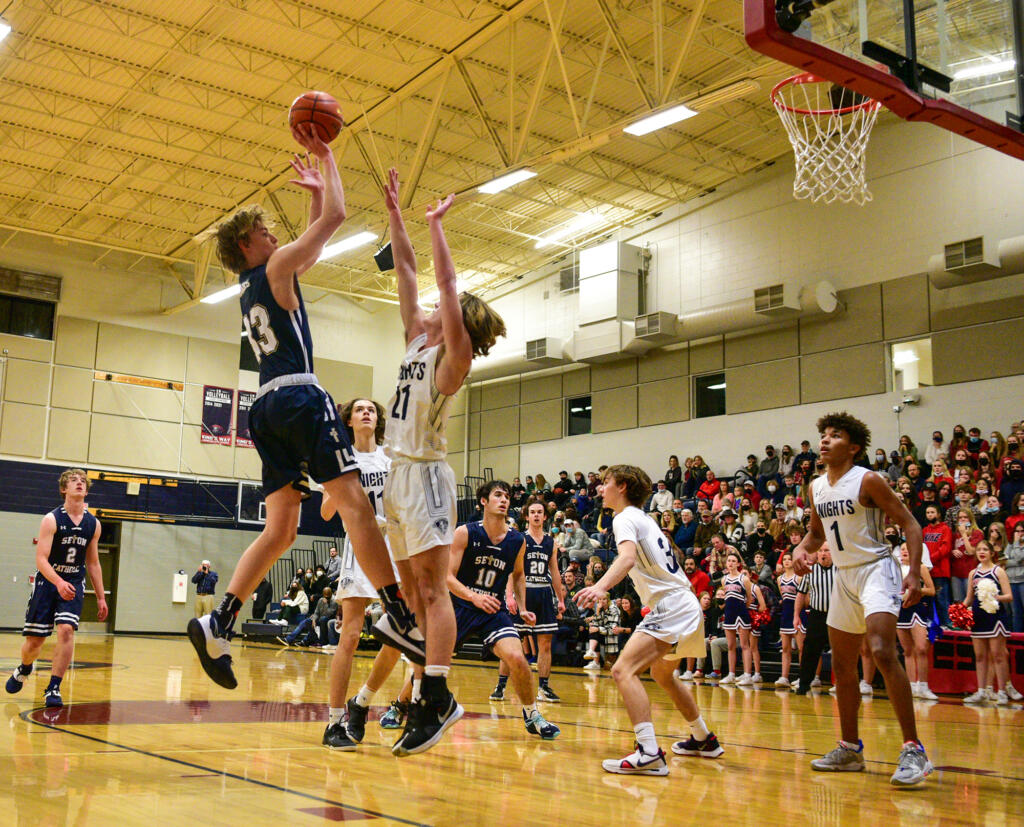 Seton Catholic junior Jack Jennings, left, shoots the ball over King’s Way Christian junior Matthew Belefski on Tuesday, Feb. 1, 2022, during the Cougars’ 32-23 loss to the Knights at King’s Way Christian High School.