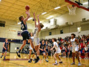 Seton Catholic junior Jack Jennings, left, shoots the ball over King’s Way Christian junior Matthew Belefski on Tuesday, Feb. 1, 2022, during the Cougars’ 32-23 loss to the Knights at King’s Way Christian High School.