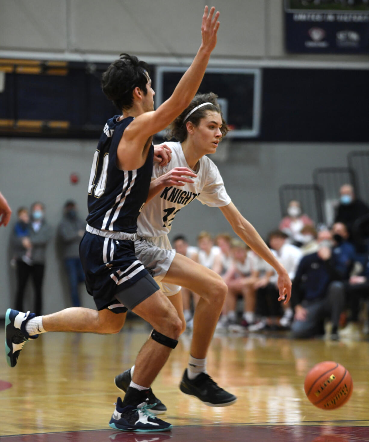 King's Way Christian junior Giovanny Evanson, right, dribbles down the court under pressure from Seton Catholic senior Jacob George on Tuesday, Feb. 1, 2022, during the Knights' 32-23 win against Seton Catholic at King's Way Christian High School.