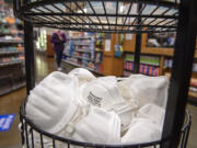 A bin full of free N95 respirator masks is pictured in the pharmacy at the QFC store in southeast Vancouver on Thursday morning, Feb. 3, 2022.