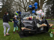 LEADSHOT Vancouver resident Cynthia Tilton, left, joins her daughter, McKynzie McFadden, 8, as they honor the memory of Officer Donald Sahota at a memorial outside the Vancouver Police Department headquarters Friday morning, Feb. 4, 2022. Tilton said Officer Sahota helped her through a difficult time in her life because he was kind and willing to listen. He was just a great guy, she said. Sahota, 52, was mistakenly shot at his home near Battle Ground by Clark County sheriffs Deputy Jonathan Feller during a manhunt for a robbery suspect Saturday night.