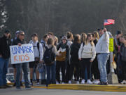 Students join a small group of protesters as they walk out of class while demonstrating against mandatory masks in schools outside Ridgefield High School on Wednesday morning, Feb. 9, 2022.