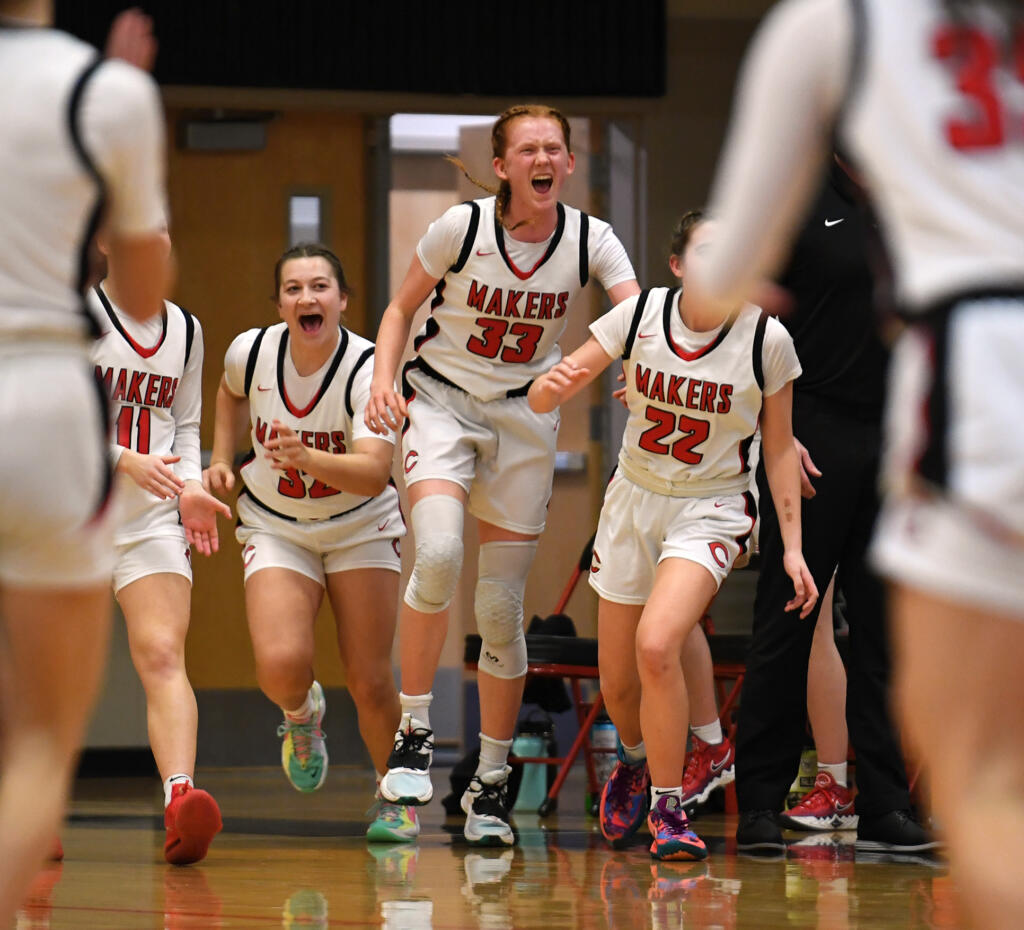 The Camas bench celebrates after Rogers-Puyallup calls timeout Friday, Feb. 11, 2022, during the Papermakers’ 65-34 win against Rogers-Puyallup at Camas High School.