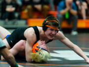 Washougal's Ryan Langston looks toward his coaches for direction as he nears a pin of Ridgefield's Drevon Cooper in the 2A Region 3 Wrestling Tournament on Saturday, Feb. 12, 2022, at Washougal High School.