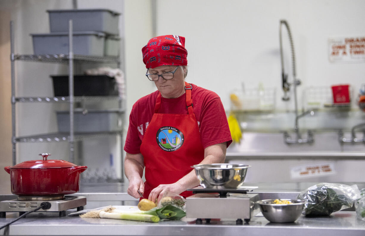 Holly Hansen of Vancouver makes coconut corn chowder, which includes some local ingredients, at Second Mile Marketplace & Food Hub on Thursday afternoon. The kitchen is aimed at adding value to locally grown agricultural products.