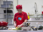 Holly Hansen of Vancouver makes coconut corn chowder, which includes some local ingredients, at Second Mile Marketplace & Food Hub on Thursday afternoon. The kitchen is aimed at adding value to locally grown agricultural products.