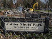 A worker removes concrete slabs at the former playground at Esther Short Park, which was destroyed by arson in January, on Wednesday afternoon, Feb. 16, 2022.