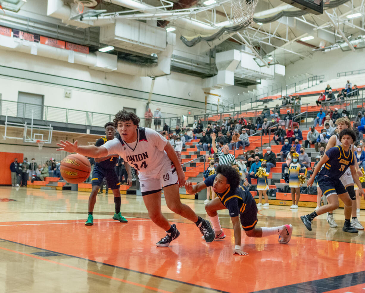 Union's Yanni Fassilis chases a loose ball in a WIAA State Regional basketball game on Saturday, Feb. 26, 2022, at Battle Ground High School.