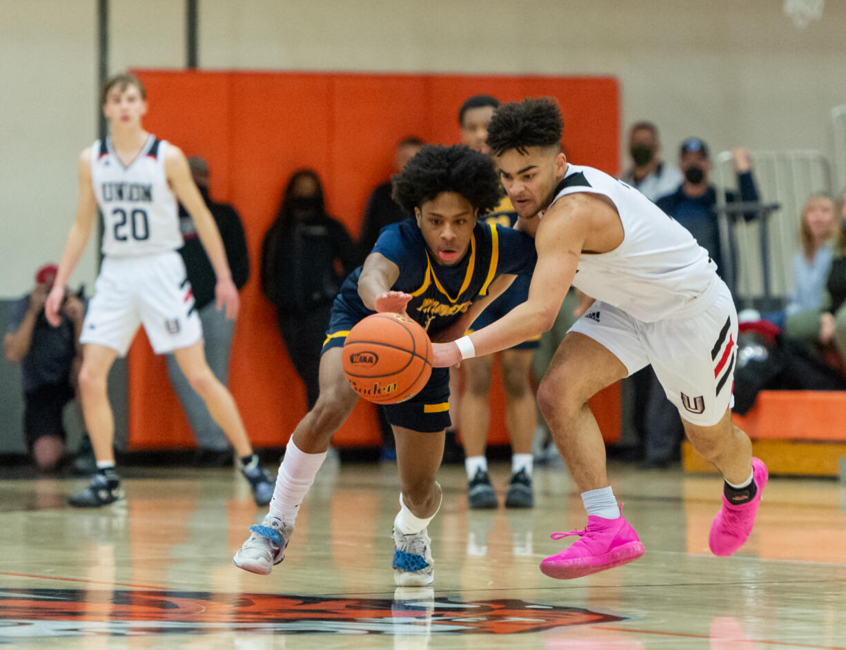 Mariner's Jailin Johnson and Union's Jamison Limbrick compete for a loose ball in a WIAA State Regional basketball game on Saturday, Feb. 26, 2022, at Battle Ground High School.