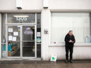 Army veteran Cliff Brown of Vancouver fills out an application to receive food vouchers near the front door of the Clark County Veterans Assistance Center on Thursday. Since the pandemic began, all services that cannot be completed over the phone are executed outside the center. "When I come into hard times these guys pull me through," Brown said.