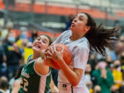 Port Angeles' Eve Burke tries to swipe the ball from the strong grasp of Hudson's Bay's Mahaila Harrison in a WIAA State Regional basketball game on Saturday, Feb. 26, 2022, at Battle Ground High School.