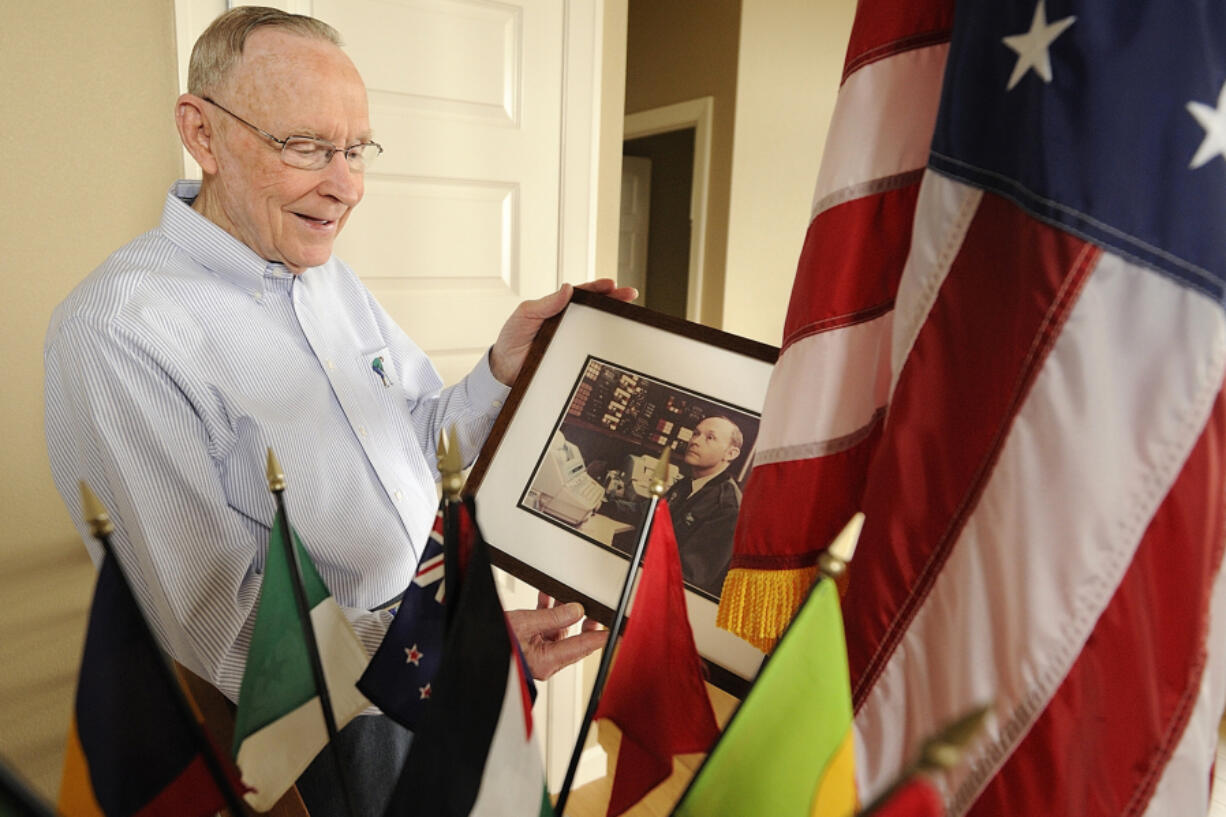 Chief Master Sgt. E.E. "Van" Valkenberg holds a picture of himself on Air Force One as he reflected on his past at his Vancouver home in 2011. Valkenberg was a radio operator in World War II and served in the U.S. Navy toward the end of the war. Soon after, he joined the Air Force where he served in the Korean War, the Cuban missile crisis and the Vietnam War.