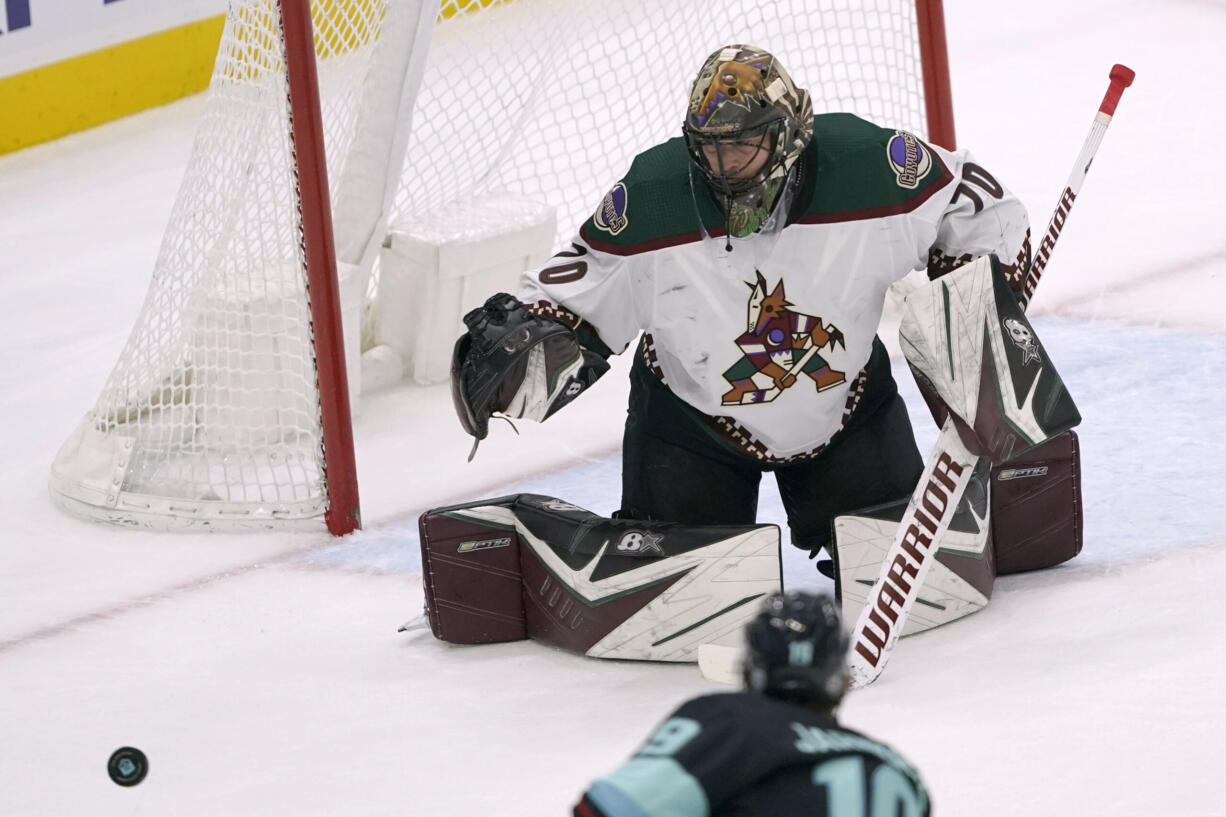 Arizona Coyotes goaltender Karel Vejmelka eyes the puck during the second period of the team's NHL hockey game against the Seattle Kraken, Wednesday, Feb. 9, 2022, in Seattle. (AP Photo/Ted S.