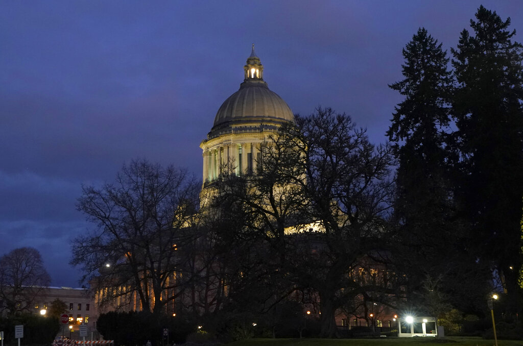 The Legislative Building is seen at dusk Tuesday, Feb. 15, 2022, following a session of the Legislature in Olympia, Wash. (AP Photo/Ted S.