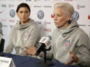 United States women's national soccer team members Alex Morgan, left, and Megan Rapinoe pictured at a 2019 press conference. U.S. women soccer players reached a landmark agreement with the sport’s American governing body to end a six-year legal battle over equal pay, a deal in which they are promised $24 million plus bonuses that match those of the men. The U.S. Soccer Federation and the women announced a deal Tuesday, Feb. 22, 2022, that will have players split $22 million, about one-third of what they had sought in damages.