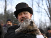 Groundhog Club handler A.J. Dereume holds Punxsutawney Phil, the weather prognosticating groundhog, during the 136th celebration of Groundhog Day on Gobbler's Knob in Punxsutawney, Pa., Wednesday, Feb. 2, 2022. Phil's handlers said that the groundhog has forecast six more weeks of winter.