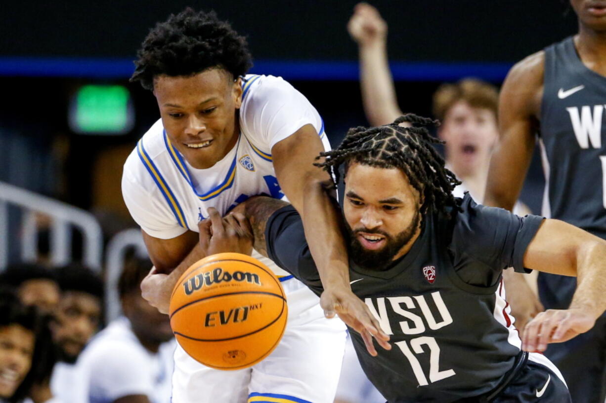 UCLA guard Jaylen Clark, left, and Washington State guard Michael Flowers compete for the ball during the first half of an NCAA college basketball game Thursday, Feb. 17, 2022, in Los Angeles. (AP Photo/Ringo H.W.