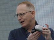 FILE - Dave Limp, senior vice president for Amazon devices & services, holds an Echo Dot with Clock device as he speaks Sept. 25, 2019, in Seattle. Amazon and telemedicine provider Teladoc Health are starting a voice-activated virtual care program that lets customers get medical help without picking up their phones. The service, for health issues that aren't emergencies, will be available on Amazon's Echo devices. Customers can tell the voice assistant Alexa that they want to talk to a doctor, and that will prompt a call back on the device from a Teladoc physician. The program, announced Monday, Feb. 28, 2022 marks Amazon's latest health care expansion and another push into telemedicine. (AP Photo/Ted S.