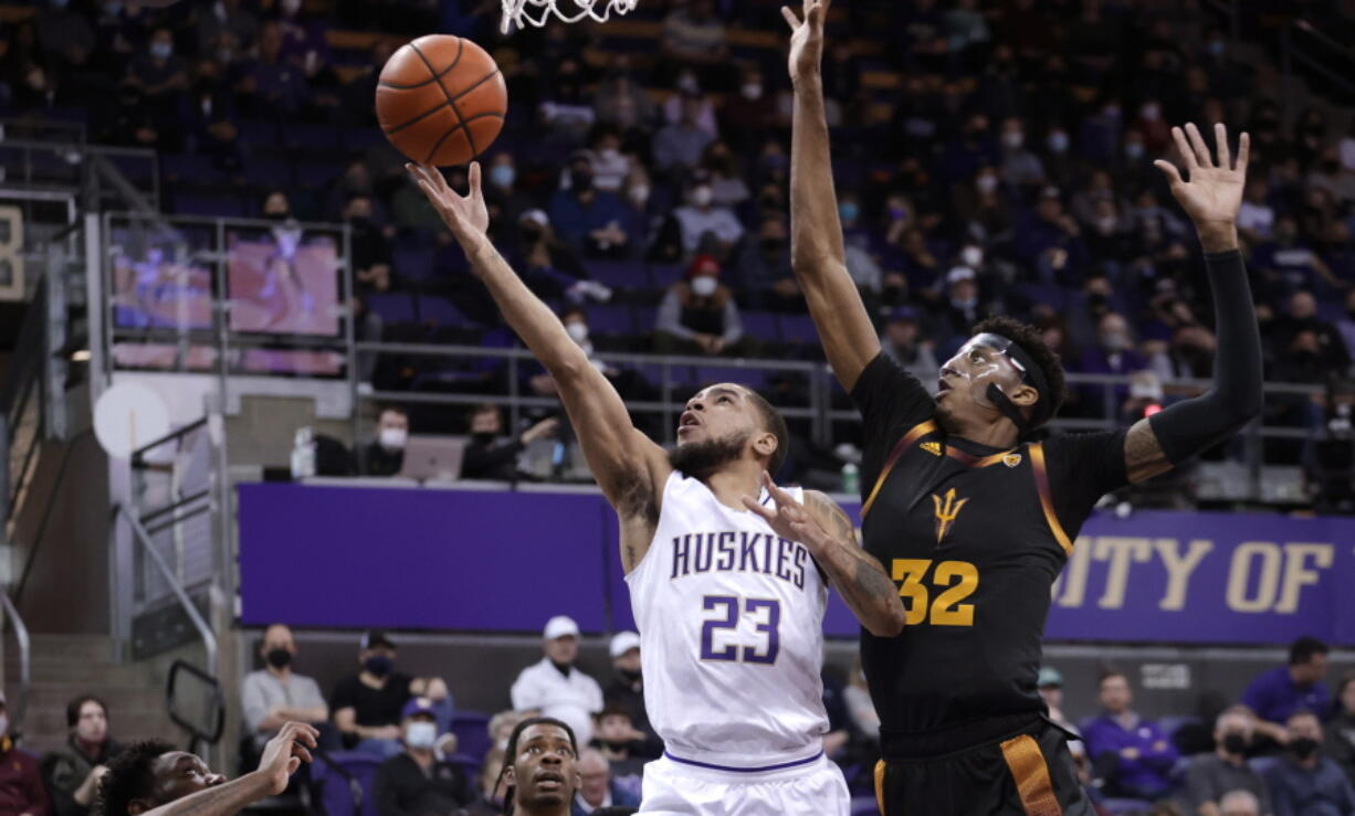 Washington's Terrell Brown Jr. shoots with  Arizona State's Alonzo Gaffney defending during the first half of an NCAA college basketball game Thursday, Feb. 10, 2022, in Seattle.