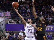 Washington's Terrell Brown Jr. shoots with  Arizona State's Alonzo Gaffney defending during the first half of an NCAA college basketball game Thursday, Feb. 10, 2022, in Seattle.