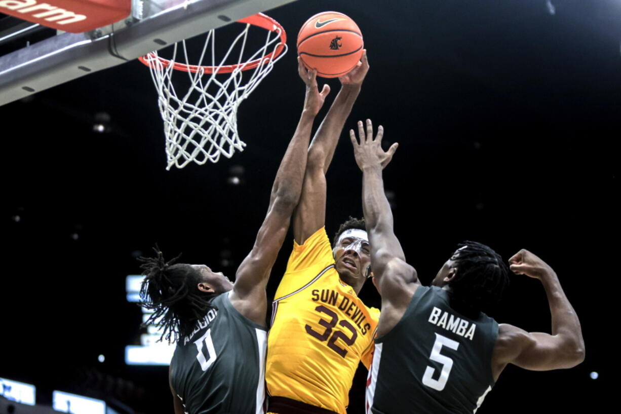 Arizona State forward Alonzo Gaffney (32) tries to shoot the ball as Washington State forward Efe Abogidi (0) blocks his shot and Washington State guard T.J. Bamba (5) defends during the first half of an NCAA college basketball game Saturday, Feb. 12, 2022, in Pullman, Wash.