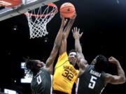 Arizona State forward Alonzo Gaffney (32) tries to shoot the ball as Washington State forward Efe Abogidi (0) blocks his shot and Washington State guard T.J. Bamba (5) defends during the first half of an NCAA college basketball game Saturday, Feb. 12, 2022, in Pullman, Wash.