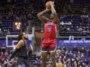 Arizona's Bennedict Mathurin shoots over Washington's PJ Fuller during the first half of an NCAA college basketball game Saturday, Feb. 12, 2022, in Seattle.