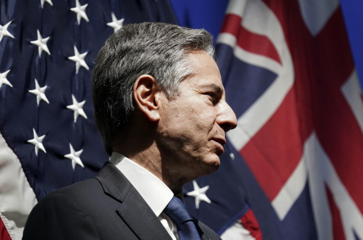 U.S. Secretary of State Antony Blinken listens as he is introduced to speak at a mission Australia meet and greet in Melbourne, Australia, Thursday, Feb. 10, 2022.