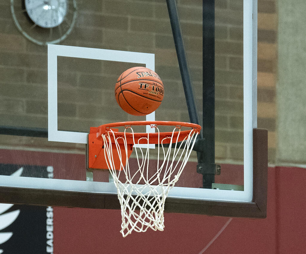 Players wait for the ball to stop bouncing on the rim in a 4A/3A Greater St. Helens League girls basketball game on Thursday, April 22, 2021, at Prairie High School. Union won 50-46.