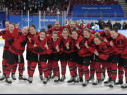 Canada poses after defeating the United States in the women's gold medal hockey game at the 2022 Winter Olympics, Thursday, Feb. 17, 2022, in Beijing.