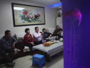 The family of Liu Wenbin, center, watches the opening ceremony of the Beijing Olympics on a television with his family at home in western Beijing on Friday, Feb. 4, 2022. Liu, a retiree from Beijing, was unable to see the event up close this year as tickets were only available to select groups owing to pandemic prevention measures. "As a Chinese person, I feel incomparably proud," Liu said. "Our great China really is no.