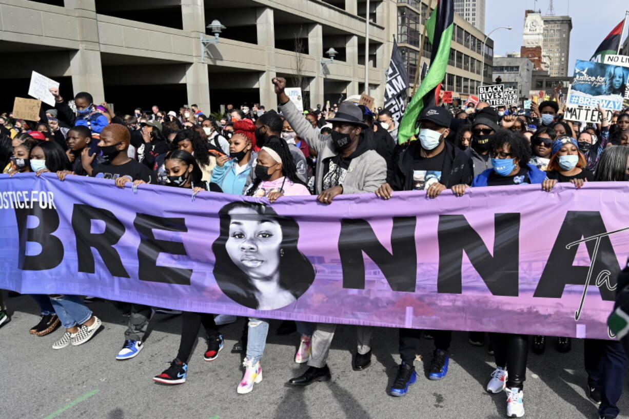 FILE - Tamika Palmer, center, the mother of Breonna Taylor, leads a march through the streets of downtown Louisville on the one year anniversary of Taylor's death on March 13, 2021, in Louisville, Ky. Questioning of potential jurors begins Tuesday, Feb. 1, 2022, for the trial of a former Kentucky police officer involved in a botched raid that killed Taylor, a 26-year-old Louisville emergency medical technician. Brett Hankison is standing trial on three counts of wanton endangerment for allegedly firing wildly into Taylor's neighbors' apartments in March 2020. No drugs were found during the raid, and the warrant was later found to be flawed.  (AP Photo/Timothy D.