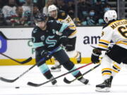 Seattle Kraken's Jordan Eberle controls the puck against the Boston Bruins in the second period of an NHL hockey game Thursday, Feb. 24, 2022, in Seattle.