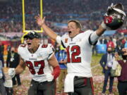 FILE - Tampa Bay Buccaneers tight end Rob Gronkowski, left, and quarterback Tom Brady (12) celebrate after the NFL Super Bowl 55 football game against the Kansas City Chiefs in Tampa, Fla., Feb. 7, 2021. Tom Brady has retired after winning seven Super Bowls and setting numerous passing records in an unprecedented 22-year-career. He made the announcement, Tuesday, Feb. 1, 2022, in a long post on Instagram.