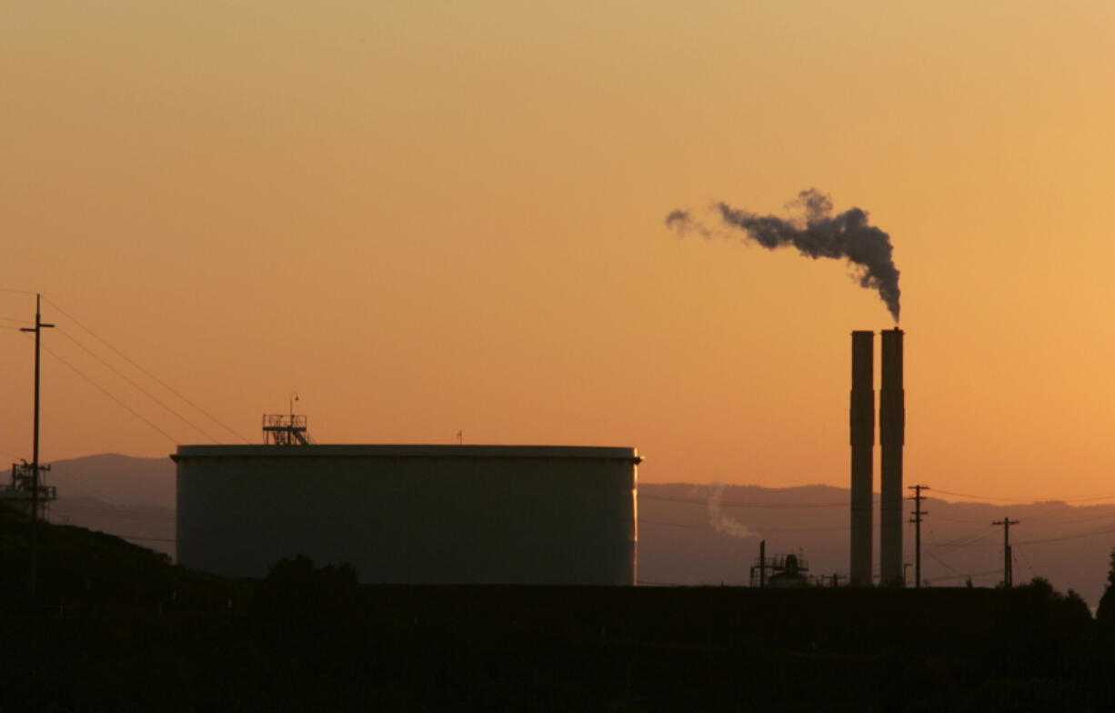 FILE - In this Friday Sept. 22, 2006 file photo, an oil refinery is seen at sunset in Rodeo, Calif. Oil refineries, electric utilities and other emitters of greenhouse gases must pay to emit carbon dioxide under the state's cap-and-trade program. But the companies in California that participate in the program have saved up to 321 million pollution allowances. A panel of experts says that could jeopardize the states' ability to meet its emissions reduction goals, according to a new report, finalized on Wednesday Feb. 9, 2022.