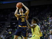 California guard Jordan Shepherd (31) shoots over Oregon guard Rivaldo Soares (11) during the second half of an NCAA college basketball game Saturday, Feb. 12, 2022, in Eugene, Ore.