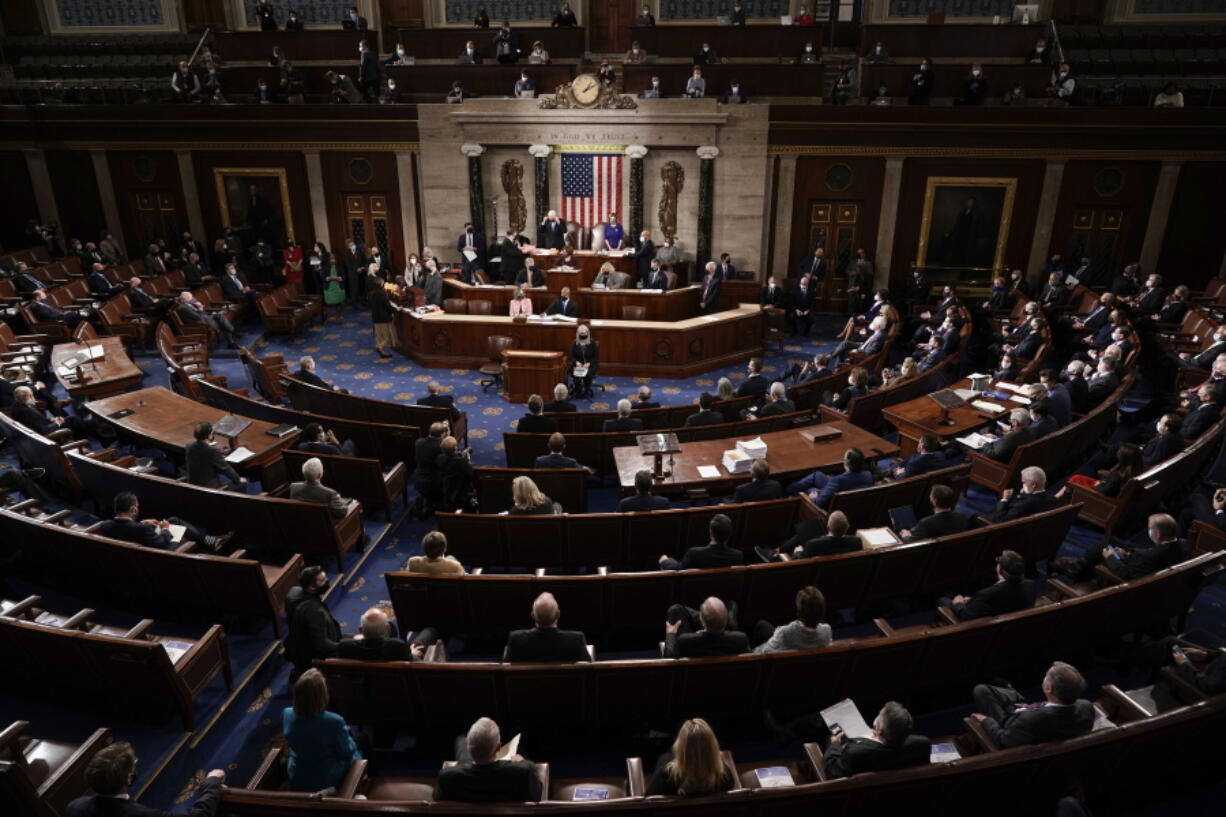 FILE - In this Jan. 6, 2021, photo, the Republican side, right, in the House chamber is seen as Speaker of the House Nancy Pelosi, D-Calif., and Vice President Mike Pence officiate as a joint session of the House and Senate convenes to count the Electoral College votes cast in November's election, at the Capitol in Washington. State attorneys general and the House committee investigating the Jan. 6 attack on the Capitol are digging deeper into the role that fake slates of electors played in the desperate effort by former President Donald Trump to cling to power after his defeat in the 2020 election. (AP Photo/J.