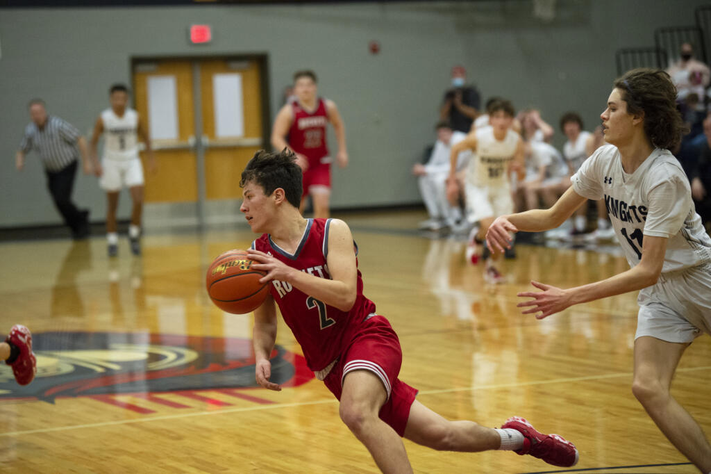 Castle Rock’s Trevor Rogen dribbles away from Giovanny Evanson after making a late seal to help seal the Rockets’ 46-43 win over King’s Way Christian in the 1A district semifinal (Tim Martinez/The Columbian)