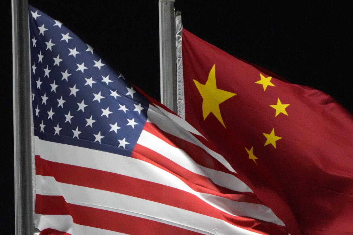 FILE - The American and Chinese flags wave at Genting Snow Park ahead of the 2022 Winter Olympics, Feb. 2, 2022, in Zhangjiakou, China.  The Biden administration is raising red flags about 33 Chinese companies whose legitimacy it cannot verify, imposing new restrictions on their ability to receive shipments from U.S. exporters and requiring extra diligence from American companies that want to do business with them.  The Commerce Department said Monday that it was adding the companies to what is known as the "Unverified List," a roster of businesses worldwide that are subjected to stricter export control because U.S.