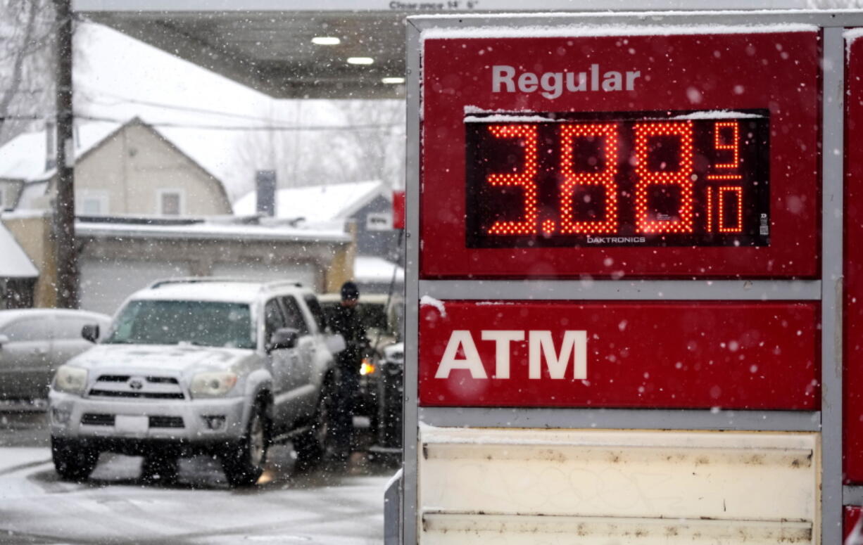 Motorists fill up vehicles at a gas station Wednesday, Feb. 16, 2022, in Denver. U.S. consumer confidence declined modestly this month but remains high, even as prices for just about everything continue to rise.