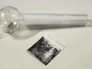 FILE - A pouch containing crystalized methamphetamine and a homemade pipe are shown March 21, 2006, in Window Rock, Ariz. Following outrage on the political right, the Biden administration said Wednesday that a grant program to help prevent additional harm to people who use illicit drugs will not pay for safer pipes to smoke crack or meth.