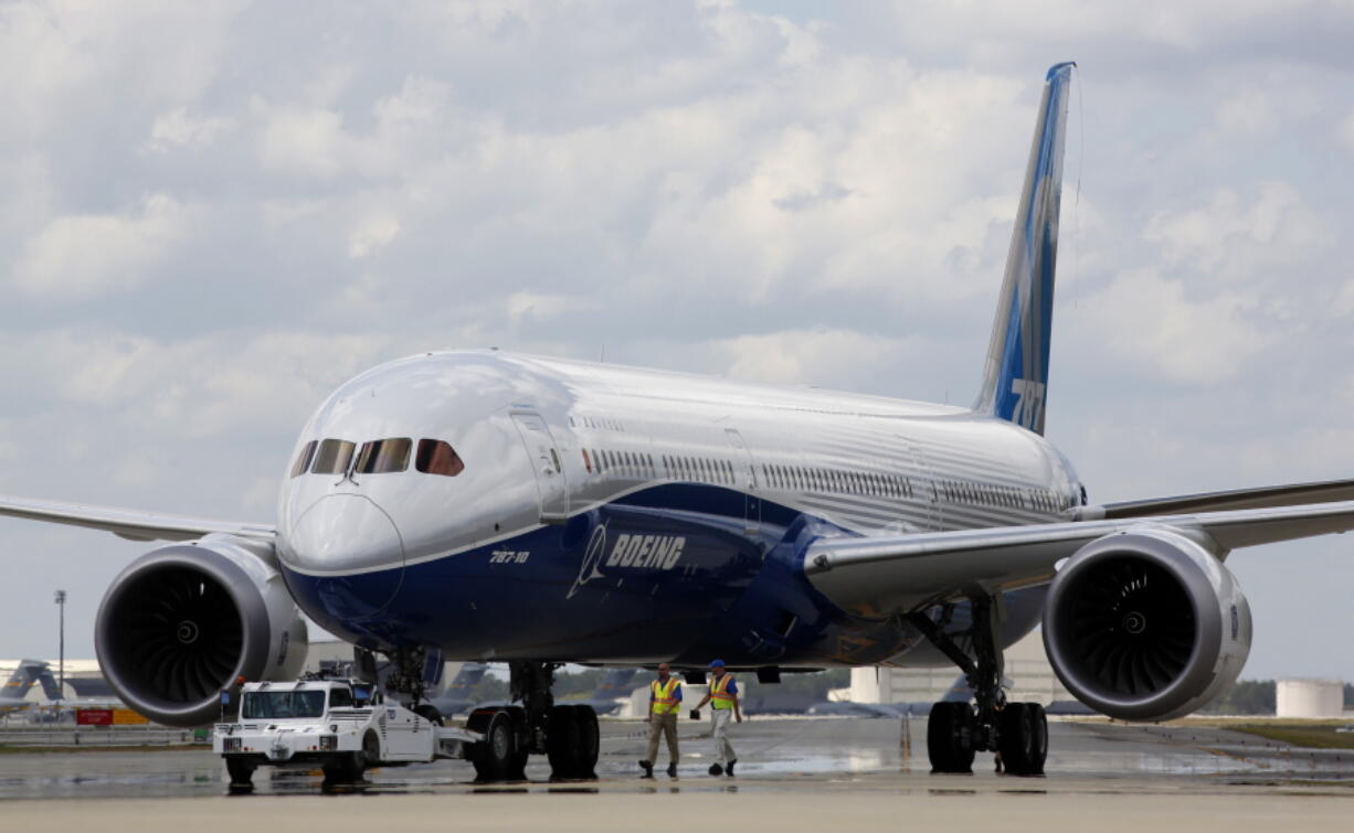 FILE - In this Friday, March 31, 2017, file photo, Boeing employees walk the new Boeing 787-10 Dreamliner down towards the delivery ramp area at the company's facility in South Carolina after conducting its first test flight at Charleston International Airport in North Charleston, S.C. Federal safety officials aren't ready to give back authority for approving new planes to Boeing when it comes to the large 787 jet, which Boeing calls the Dreamliner, Tuesday, Feb. 15, 2022.